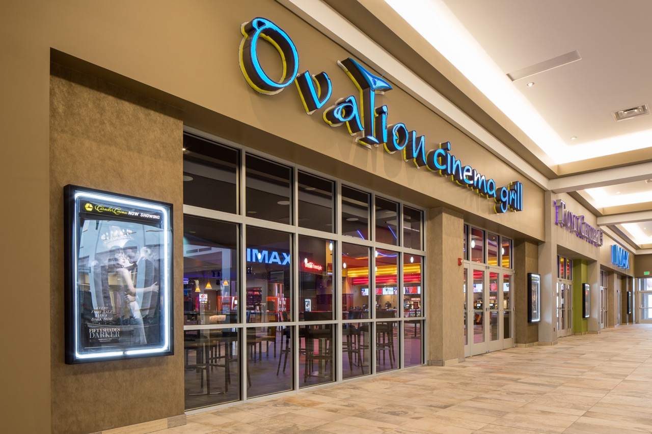 Ovation grill sign on an outdoor strip mall building.