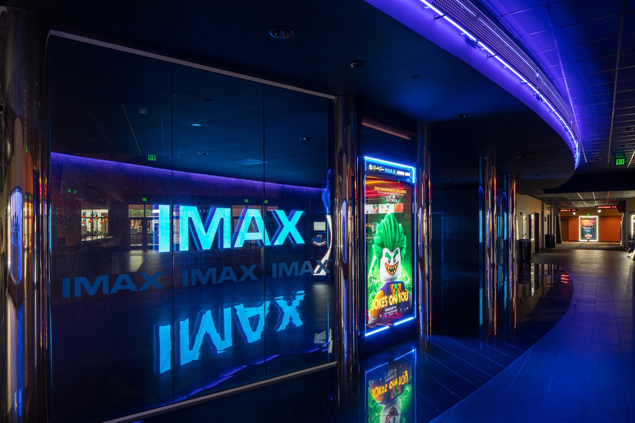 IMAX entrance with a lit movie theater poster.